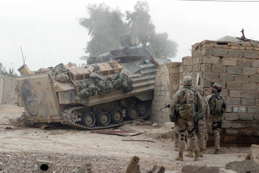 17 Nov 2004: An Amphibious Assault Vehicle (AAV) drives through a wall and locked gate to open a path for Marines from 2nd Platoon, India Company, 3rd Battalion, 1st Marines, 1st Marine Division to gain entrance to a building that needed to be cleared. Operation Al Fajr is an offensive operation to eradicate enemy forces within the city of Fallujah in support of continuing security and stabilization operations in the Al Anbar province of Iraq by units of the 1st Marine Division. Official USMC Photograph by LCpl Ryan L Jones